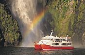 Red Boat beneather waterfall